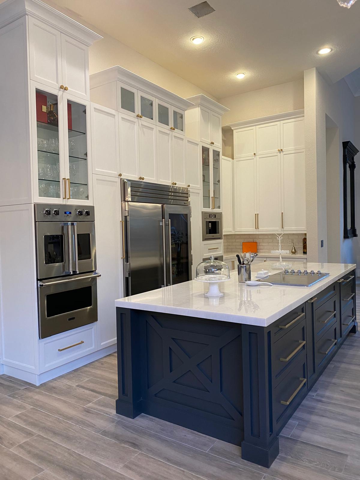 Parkland Kitchen ΓÇö vertical wood grain cabinetry with marble counters and island